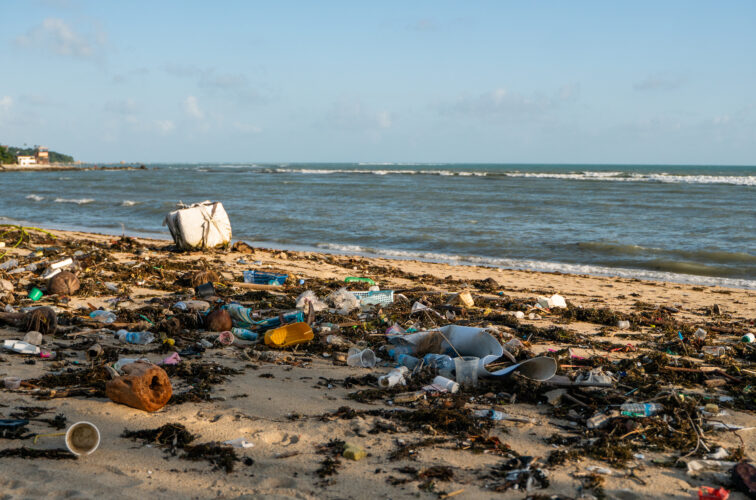 KOH SAMUI, THAILAND - December 15, 2019: Beach pollution such as Plastic bottles and other trash on sea beach in Koh Samui island.